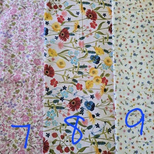 May include: Three floral fabric swatches. The first is pink with small flowers. The second is white with red, yellow, and blue flowers. The third is white with tiny yellow and pink flowers. Numbers 7, 8, and 9 are written on the fabric.