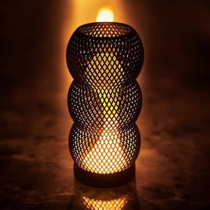 May include: A black, decorative candle holder with a lattice design. The candle holder has a cylindrical shape with three stacked, spherical sections. The interior glows with warm yellow light, and a small flame is visible at the top.