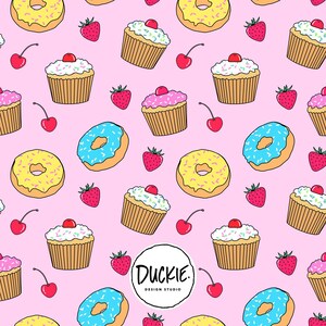 May include: A repeating pattern on a light pink background featuring illustrations of yellow donuts with sprinkles, blue donuts with sprinkles, cupcakes with white or pink frosting and cherries, and red strawberries. Text reads DUCKIE DESIGN STUDIO.