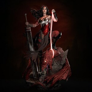 May include: A detailed statue of a female warrior in a red and silver outfit, holding a large sword and standing on a red dragon. The warrior has long dark hair and a red headband. A red energy beam extends from her hand.