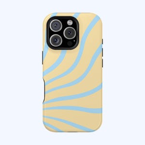 May include: A phone case with a light yellow background and light blue wavy lines. The case has a black camera module with three lenses and a flash. The case is designed to fit a smartphone.