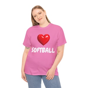 Op de afbeelding: Roze t-shirt met een rood hart en het woord "SOFTBALL" in het wit. Het shirt is gemaakt van zachte stof, geschikt voor dagelijks gebruik.