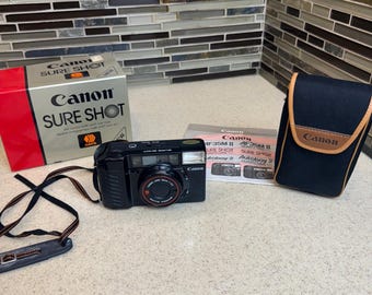 Cámara de película Canon Sure Shot Autoboy 2 AF35M II de 35 mm en caja original con estuche. Probada.
