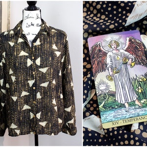 May include: A black and white patterned button-up shirt with a long sleeve. The shirt has a geometric pattern of small dots and larger triangles. The shirt is on a white background.