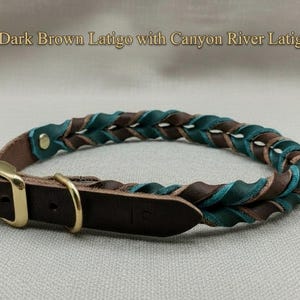 May include: A braided leather collar featuring dark brown and canyon river teal latigo leather strands. The collar includes a gold-toned metal buckle and a D-ring, with the text Dark Brown Latigo with Canyon River Latigo displayed above.