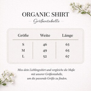 May include: A white graphic with the text "ORGANIC SHIRT" and "Gr&ouml;&szlig;entabelle". The graphic includes a size chart with sizes S, M, and L, and measurements in centimeters for width and length. Floral accents are in the corners.
