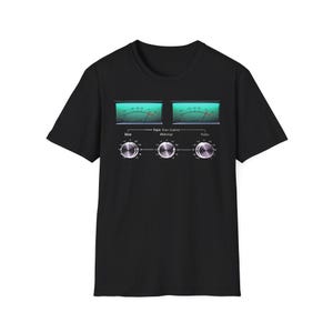 May include: Black t-shirt featuring a graphic of a triple tone control panel with meters and knobs. The design includes the words "Bass", "Midrange", and "Treble". The meters have a green background.