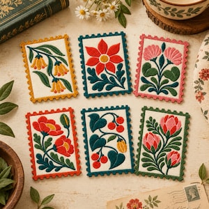 May include: Six rectangular embroidered patches shaped like postage stamps, each featuring a unique floral design. The designs include yellow bell-shaped flowers, a large red flower, pink blossoms, red poppies, red berries, and pink buds on green stems.