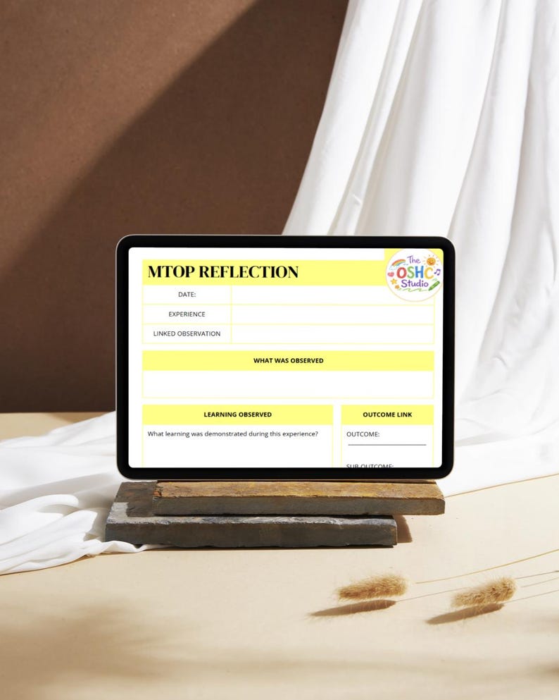 May include: A black tablet displaying a "MTOP REFLECTION" form with yellow highlighted sections. The form includes fields for date, experience, and linked observation. The OSHC Studio logo is in the top right corner. The tablet rests on a stack of wooden blocks.
