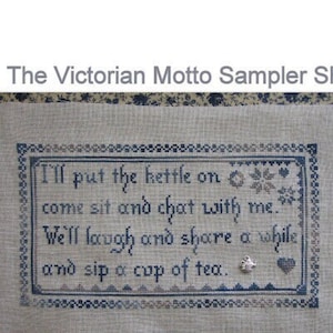 May include: A cross-stitch sampler with the text "I'll put the kettle on come sit and chat with me. We'll laugh and share a while and sip a cup of tea." The sampler is framed in a blue and white border.