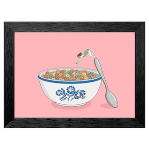 May include: A framed print featuring a whimsical illustration. A person in a green swimsuit dives into a bowl of colorful cereal. A large spoon is positioned next to the bowl. The bowl has a blue floral design and sits on a pink background.
