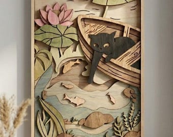 May include: Wooden wall art depicting a black cat in a boat on a pond. The artwork includes a pink lotus flower, lily pads, fish, and aquatic plants. The frame is made of light-coloured wood, creating a layered, three-dimensional effect.