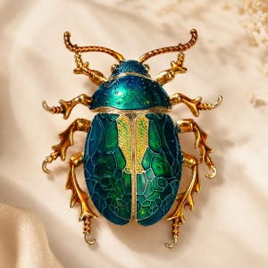 May include: A detailed, jewel-toned beetle brooch. The insect features a metallic gold frame with a blue-green iridescent shell and gold-colored legs and antennae. The brooch is an ornate, decorative accessory.