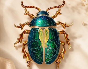 Emaille keverbroche, blauwgroene insectensieraden, statement dierenpin, koperen zirkoonaccessoire