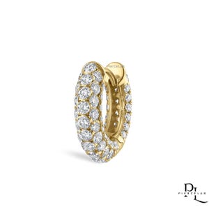 May include: A yellow gold hoop earring featuring a pavé setting of numerous round white stones covering the outer surface. The earring has a hinged closure mechanism and includes the text PierceLab printed in the lower right corner.