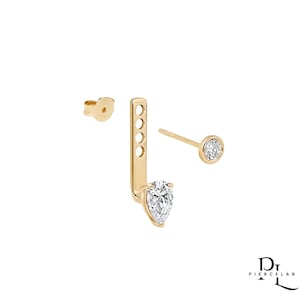 May include: A set of three gold-colored earrings. One is a stud with a round, bezel-set diamond. Another is a post with a pear-shaped diamond. The third is a gold earring back. The earrings are displayed on a white background.