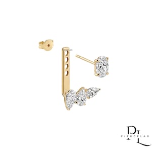 May include: A gold ear jacket earring featuring a post with an oval-cut clear stone and a detachable bar component with three pear-cut clear stones. The bar has four adjustment holes and includes a matching gold earring back. Text reads PierceLab.