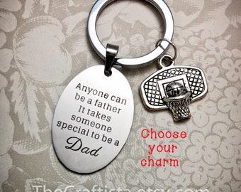 May include: Silver keychain with a basketball hoop charm and an oval tag that reads "Anyone can be a father. It takes someone special to be a Dad."