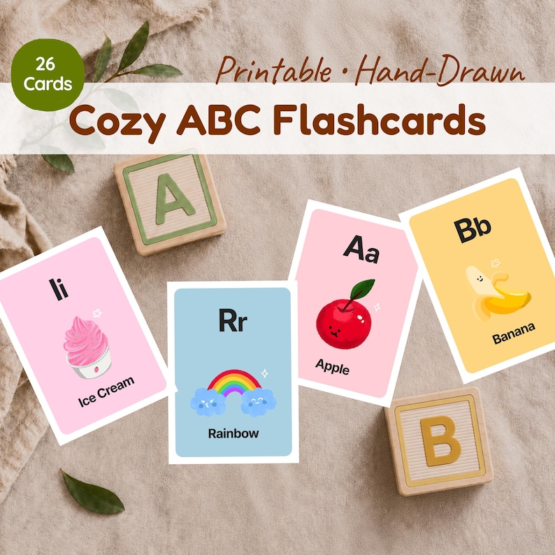 A set of 26 hand-drawn alphabet flashcards for toddlers. The image shows printable cards for letters A, B, I, and R with soft pastel colors and hand-drawn graphics, labeled 'Cozy ABC Flashcards