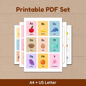 A stack of printable PDF pages showing the alphabet card layouts. The image is titled 'Printable PDF Set' and specifies both A4 and US Letter sizes are included, presented on a light wood textured background.