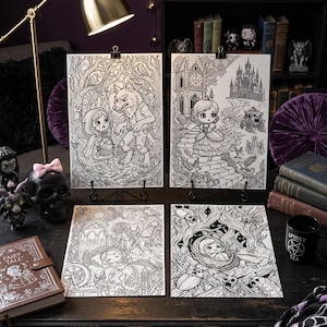 May include: Four black and white coloring pages featuring intricate illustrations of fairy tale characters and scenes, including a girl with a wolf, a castle setting, a spinning wheel, and a forest scene with insects, all presented on a dark desk.