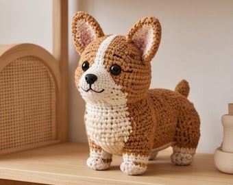 May include: A crochet corgi dog figurine featuring brown and white yarn. The plush toy has large pointed ears, a white stripe running from its forehead to its chest, black plastic eyes, and a small black nose with a stitched mouth detail.