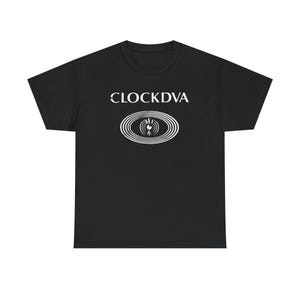 May include: A black short-sleeved t-shirt featuring the white text CLOCKDVA centered on the chest above a white graphic of a stylized eye surrounded by concentric oval rings. The design is printed in a clean, bold, and high-contrast white ink.