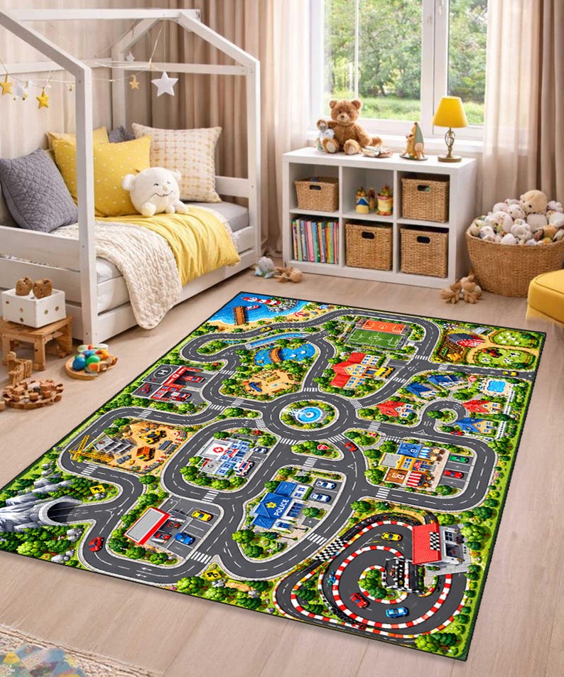 May include: A rectangular area rug featuring a colorful printed city map design with winding roads, a police station, a hospital, a construction site, a race track, and various buildings, all set against a green landscape with trees.