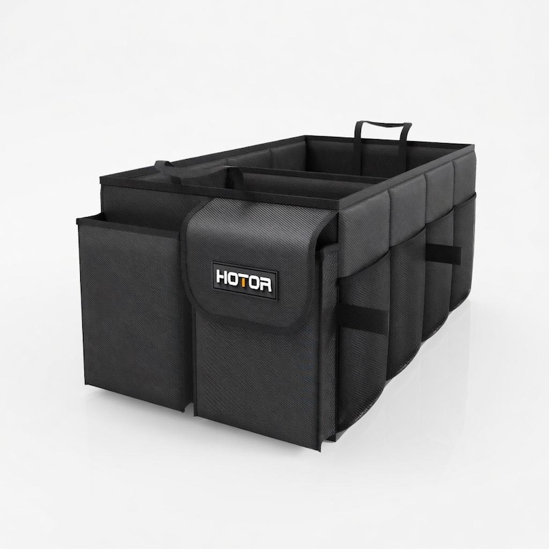 May include: Black car trunk organizer with multiple compartments and pockets. The organizer has a handle for easy carrying and the word "HOTOR" is printed on the front.