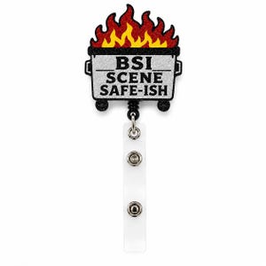 May include: A retractable badge reel with a glittery design. The design features a dumpster on fire with the text "BSI SCENE SAFE-ISH". The reel has a clear plastic strap with two snap closures.