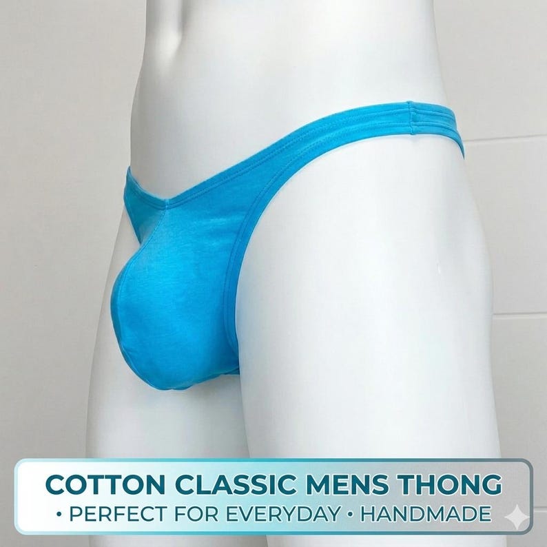 May include: A light blue cotton thong. The underwear has a classic design and is handmade. The text on the image reads "COTTON CLASSIC MENS THONG".