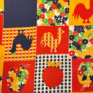 May include: A colorful fabric with a patchwork design featuring farm-themed motifs. The squares display a rooster, apple, and floral patterns in red, yellow, navy, and white. The fabric has a vintage, retro aesthetic.