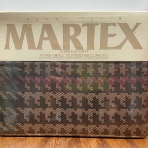 May include: A packaged queen flat sheet by Martex. The sheet features a brown, green, and burgundy houndstooth pattern. The packaging includes the brand name and product details.