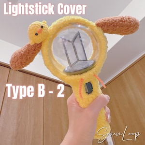 May include: A set of three ceramic mugs with a speckled, cream-colored glaze. Each mug features a different hand-painted floral design in shades of blue, green, and yellow. The mugs have a simple, modern shape.