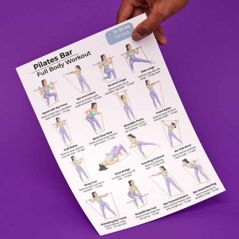 May include: A white Pilates Bar Full Body Workout chart held by a hand. The chart features illustrated exercises with instructions, including squats, lunges, and presses. The text indicates a 15-20 minute workout.