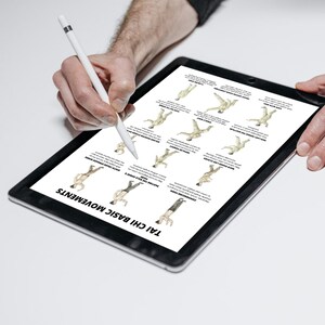 May include: A black tablet displaying a diagram of Tai Chi basic movements. The diagram shows illustrations of various poses with accompanying text. A white stylus is held over the tablet, suggesting interaction with the content.