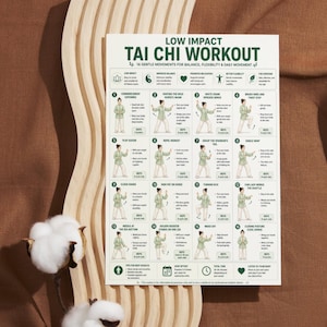 May include: A white poster with the title "LOW IMPACT TAI CHI WORKOUT" and illustrations of 16 gentle movements. The poster is on a brown surface with a cotton plant in the corner.