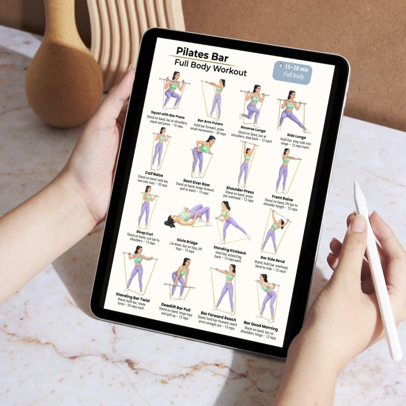 May include: A tablet displays a Pilates Bar full-body workout routine. The screen shows illustrated exercises with a woman demonstrating each move. The tablet is held by a person, with a stylus in the other hand. The text "Pilates Bar Full Body Workout" is visible.