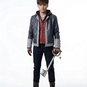 May include: A person wearing a blue and gray leather jacket over a red hooded shirt, black jeans, and brown boots. They are holding a large silver and gold key. The outfit has a cosplay or fantasy theme.