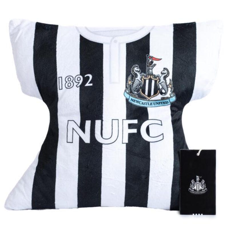 May include: A plush pillow shaped like a Newcastle United football jersey. The pillow features black and white stripes, the number "1892", and the letters "NUFC". The team crest is displayed on the upper right. A black tag with the team crest is attached.