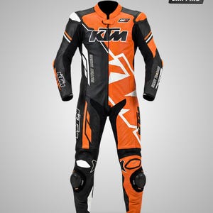 May include: A black, orange, and white leather motorcycle racing suit featuring the KTM logo on the chest, shoulders, and legs. The suit includes a mandarin collar, long sleeves, and integrated knee protectors, with white geometric accents throughout.