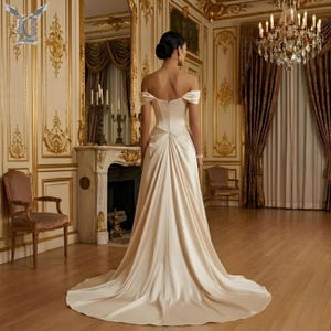 Minimalist satin bridal gown featuring elegant back design and extended chapel train for modern brides