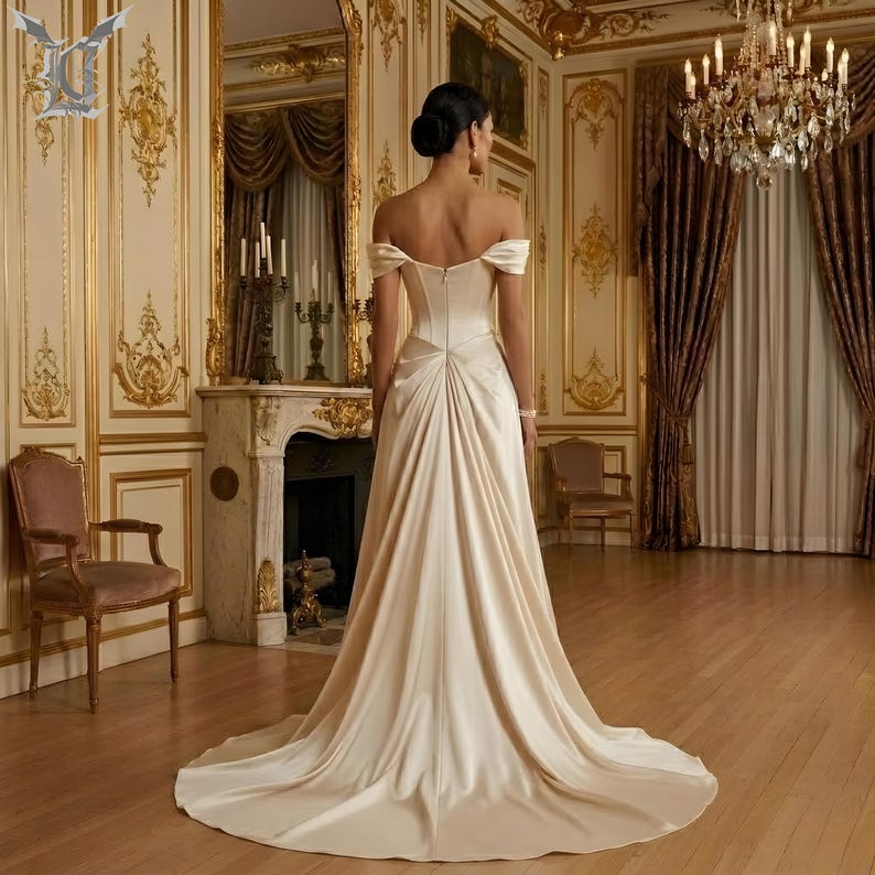 Minimalist satin bridal gown featuring elegant back design and extended chapel train for modern brides