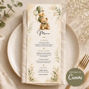 May include: A vertical menu card featuring a watercolor illustration of a teddy bear holding balloons, decorated with green foliage accents. The text reads Menu, Starters, Main Course, and Dessert, with a small badge stating Editable in Canva.