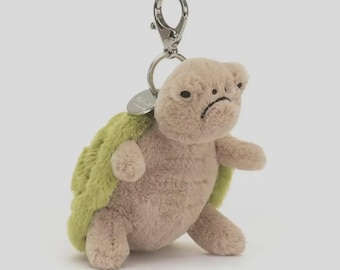 Novo chaveiro de pelúcia de tartaruga da Amuseables, pingente macio para bolsa, acessório com sorriso bordado.
