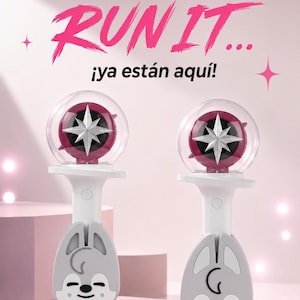 May include: Two light sticks featuring a white handle with a grey cartoon wolf face at the base and a clear dome top containing a dark pink star emblem. The text reads: Al igual que el nuevo éxito RUN IT... ¡ya están aquí!