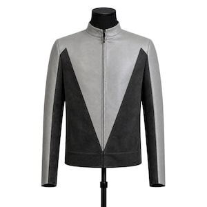 May include: A two-tone jacket with a stand-up collar and a full-length zipper. The jacket features a gray upper section and black lower section in a V-shaped design. The sleeves are gray, and the jacket is displayed on a black mannequin.