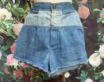 May include: High-waisted denim shorts with a light blue and dark blue patchwork design. The shorts have a frayed hem and a button closure.