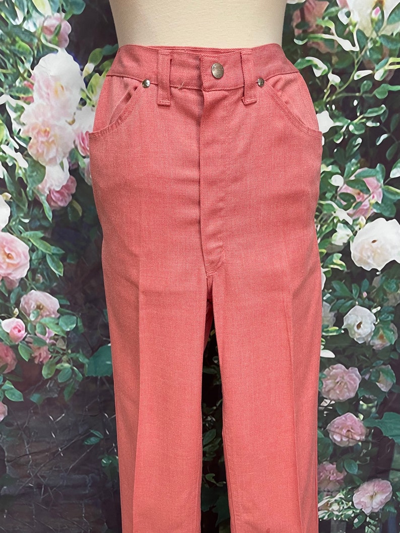 May include: A pair of salmon-colored pants with a straight leg and a high waist.