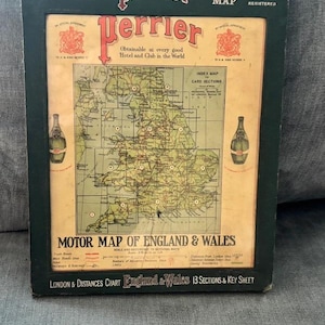 May include: A vintage framed Perrier Motor Map of England & Wales. The map features a grid layout, illustrations of two green glass bottles, and text including The Perrier Map, Obtainable at every good Hotel and Club in the World, and 13 Sections & Key Sheet.